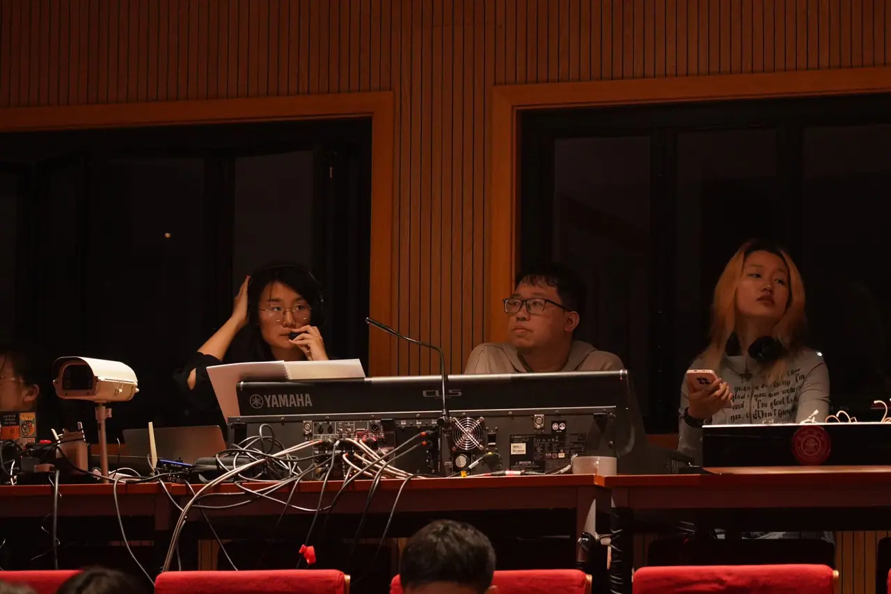 Kaibin Wang working in a theater control booth